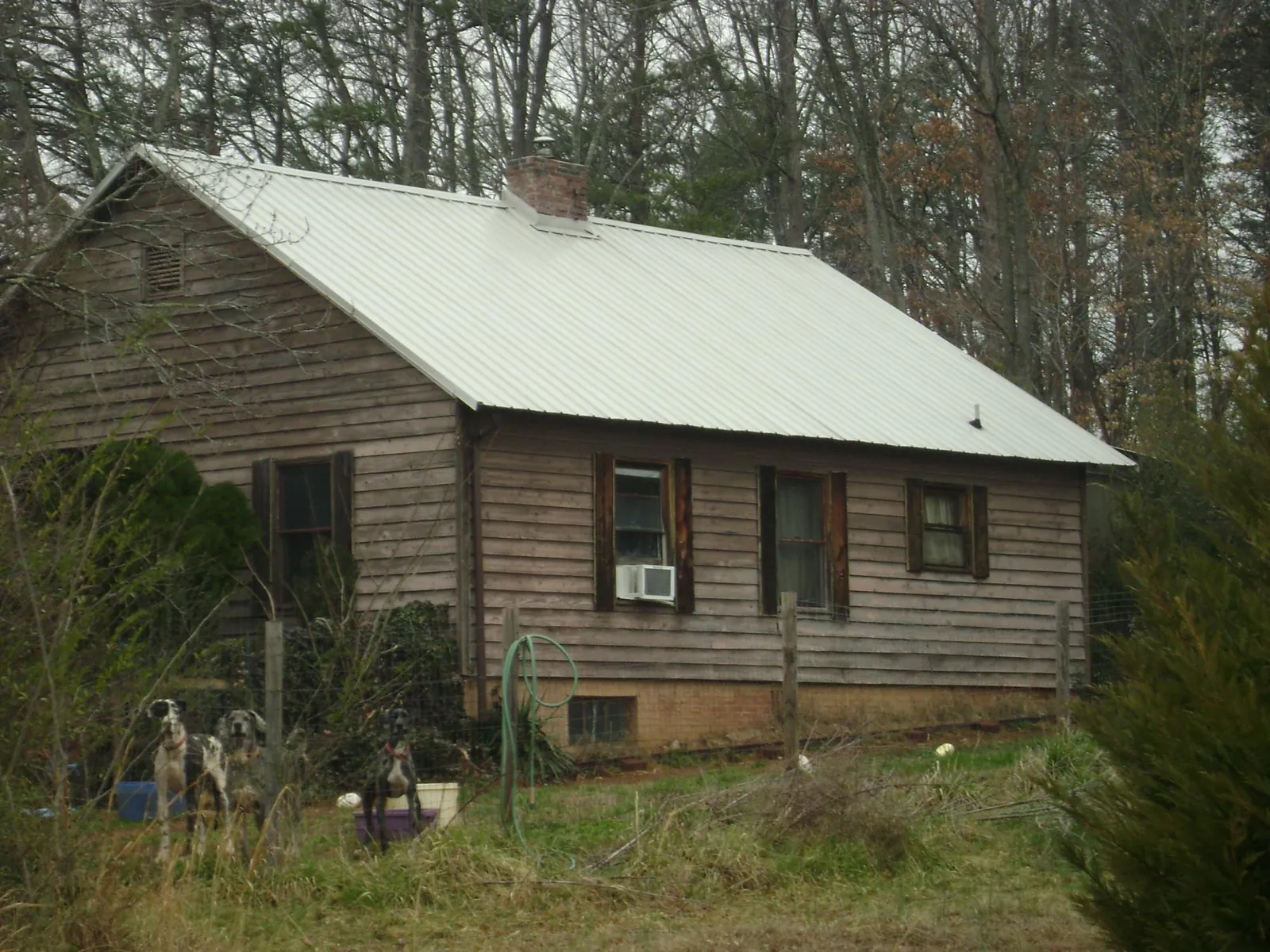 White metal roof on an old wood sided farmhouse, from a Asphalt Shingle Roof Repair job in Boydton